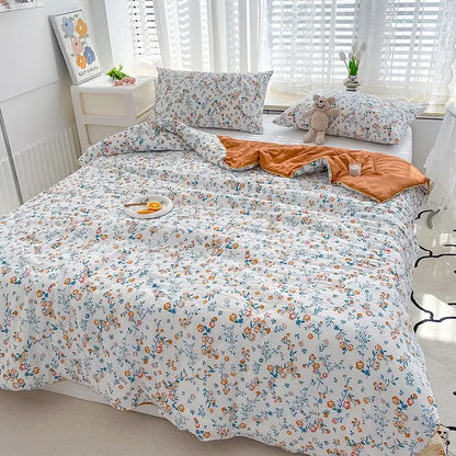 White floral patterned double gauze quilt with orange inner lining featuring embroidered double gauze rabbit print design