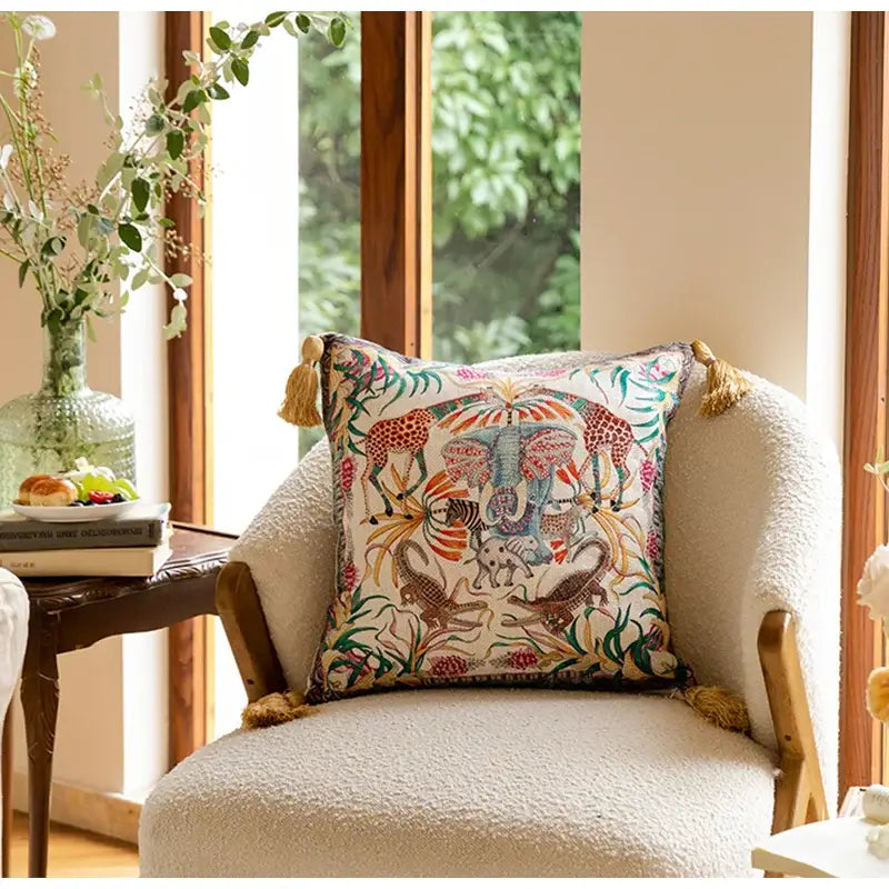 A vibrant embroidered elephant jungle paradise throw pillow featuring colorful elephants and giraffes for living room decorbites decor
