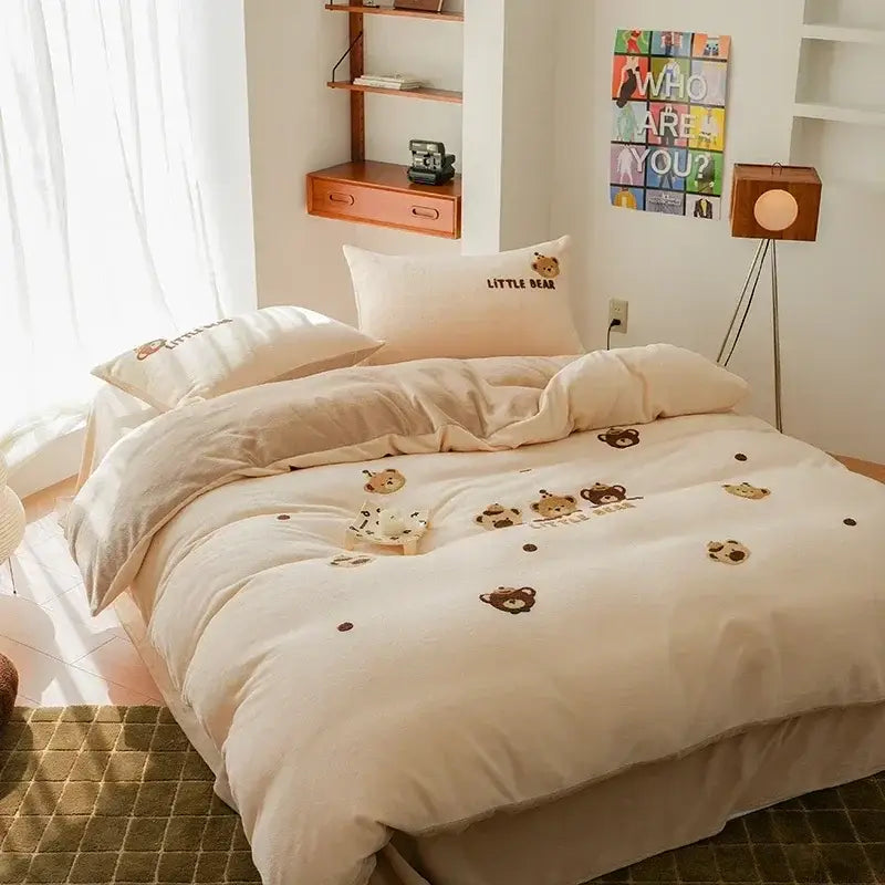Cream-colored embroidered fleece winter bedding set featuring brown bear faces and dots on duvet pillowcases and skirt