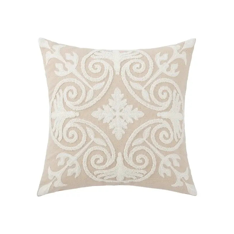 Beige square pillow cover with intricate white embroidered floral and scrollwork design for living room decor