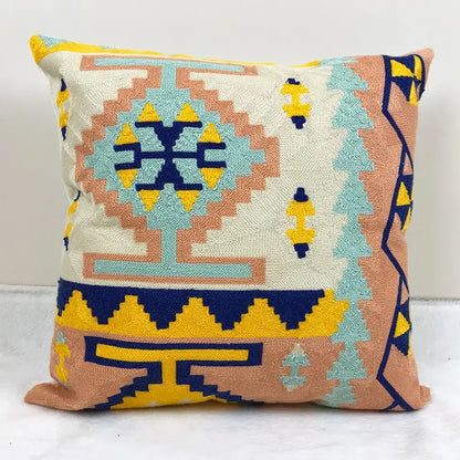 Square cushion cover with embroidered kilim style geometric design in cream peach turquoise and navy blue for living room