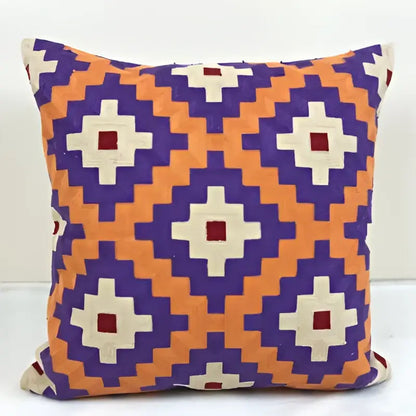 Vibrant embroidered kilim style cushion cover with bold orange purple and cream geometric diamond motif for living room use