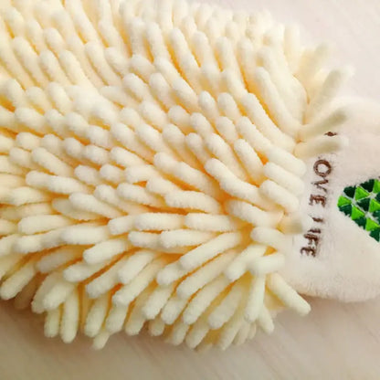 Cream-colored plush scrubbing mitt with soft bristles and green logo paired with embroidered microfiber hand towel pale green and cream