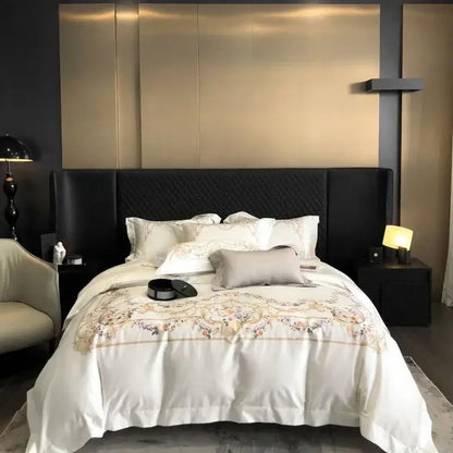Embroidered white egyptian cotton bedding set featuring a satin duvet cover with floral embroidery and quilted black headboard