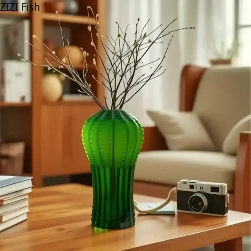 A translucent emerald green frosted glass cactus frosted vase with vertical ridges holding bare branches for living room decor