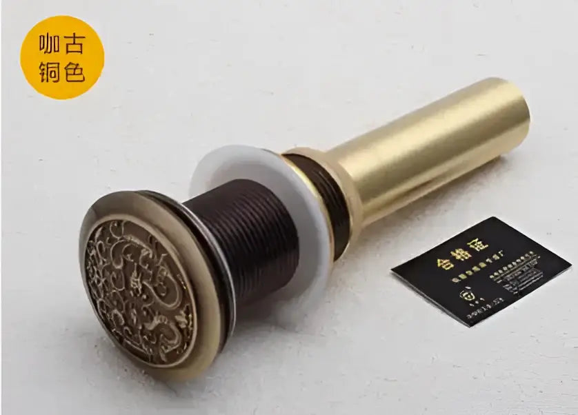 Engraved brass bathroom sink pop up drain stopper with intricate design and white rubber seal for decorbites brass bathroom