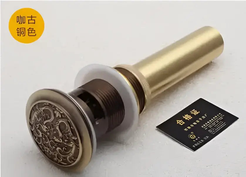 Antique brass bathroom sink pop up drain stopper with engraved floral design and white rubber seal for decorbites brass bathroom use