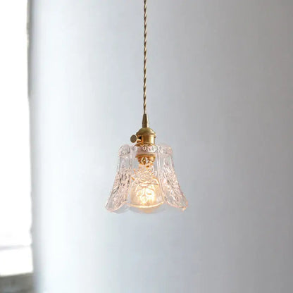 Etched glass pendant light in polished copper with floral etchings and warm glow for dining room use