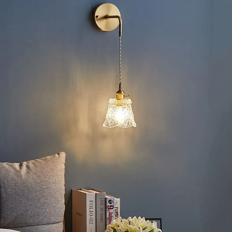 A delicate etched glass pendant light in polished copper with a textured glass shade for dining room use
