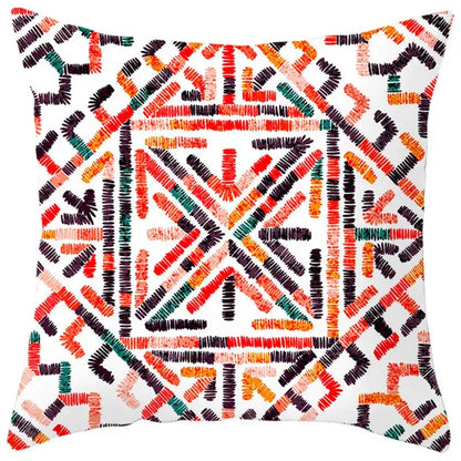Square throw pillow cover with ethnic bohemian geometric pattern in bold reds oranges greens and black lines on white decorbites decor
