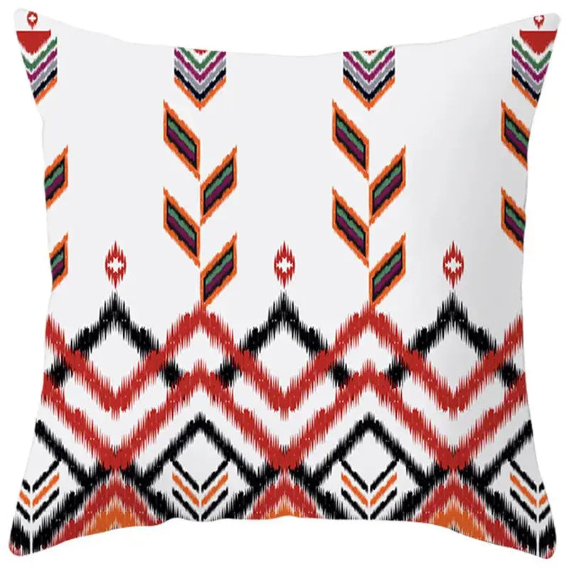 White throw pillow cover with vibrant red black orange and green ethnic bohemian geometric pattern for living room decorbites decor