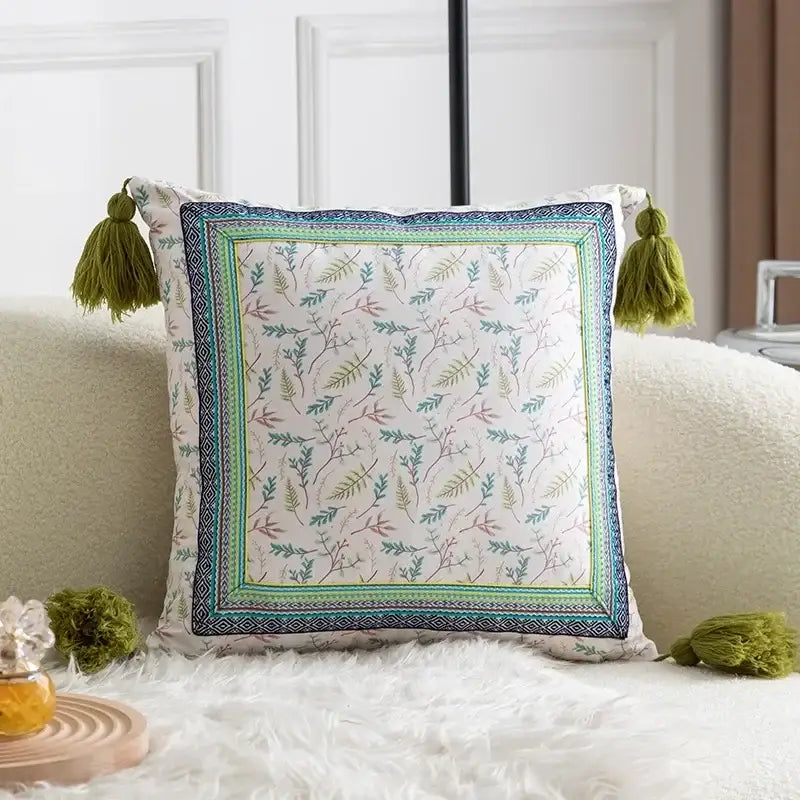 Square botanical pillow cover set in teal and navy with cream fabric and olive green tassels for living room decor