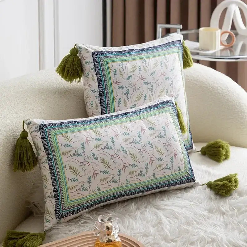 Two rectangular decorative throw pillows with ethnic botanical teal and navy print pillow cover set with tassels