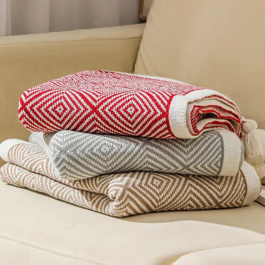 Stacked ethnic geometry knitted throw blankets in red white gray cream and beige brown tones for living room sofa decorbites