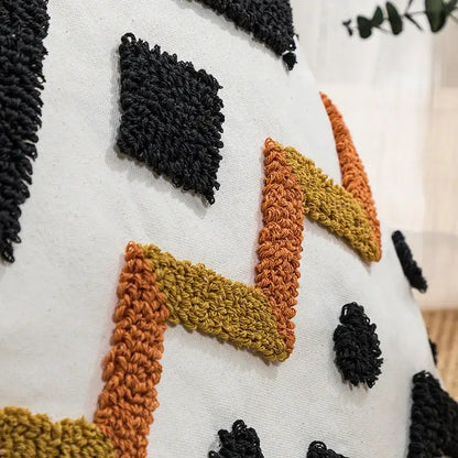White cushion cover with chunky black orange and mustard yellow crochet pattern decorbites ethnic style black geometric decor