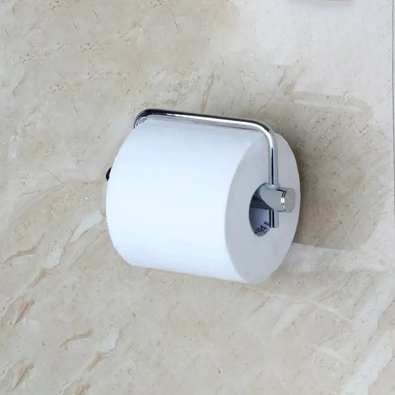 A euro silver chrome paper holder by decorbites featuring a sleek design cradling a white toilet paper roll for euro silver bathroom use