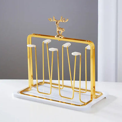 Gold-toned metal cup holder with marble base and decorative deer figurine for european glass storage rack use