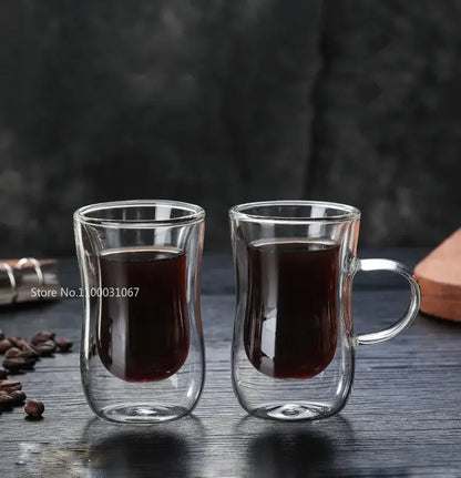 European style clear double glass insulated tea cups with handles filled with dark liquid for kitchenware use