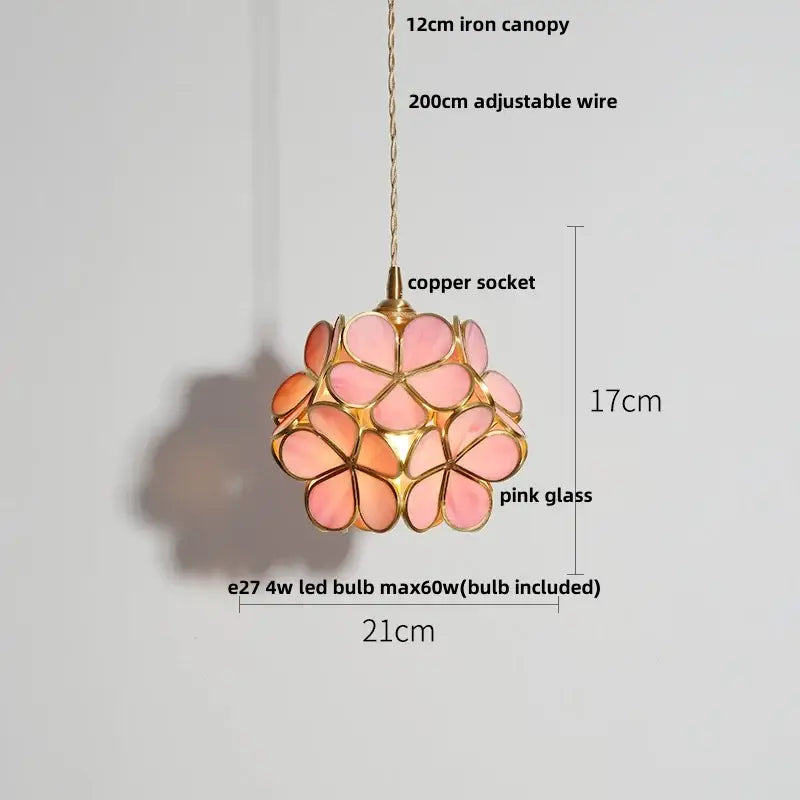 A delicate pink faceted decorbites clear glass pendant lamp with gold frame and copper socket for dining room use