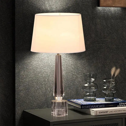 Elegant decorbites crystal table lamp with a faceted base and off-white fabric shade for bedroom light fixture