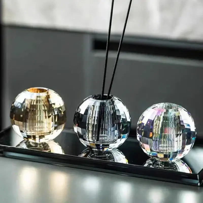 Faceted gold crystal ball aroma diffuser holders with geometric base in gold, clear silver, and rainbow iridescent colors