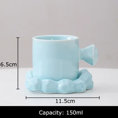 Faceted light blue porcelain coffee mug set with candy cane style handle and matching saucer for kitchen decor