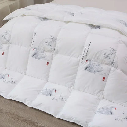 White goose down quilt in white with embroidered swans and floral motifs in soft gray tones accented by red seals