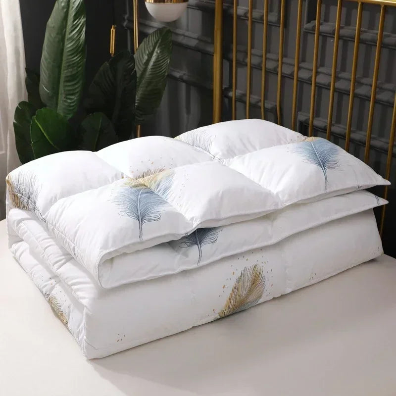 White goose down quilt in white with delicate blue and gold feather embroidery for winter bedding comfort