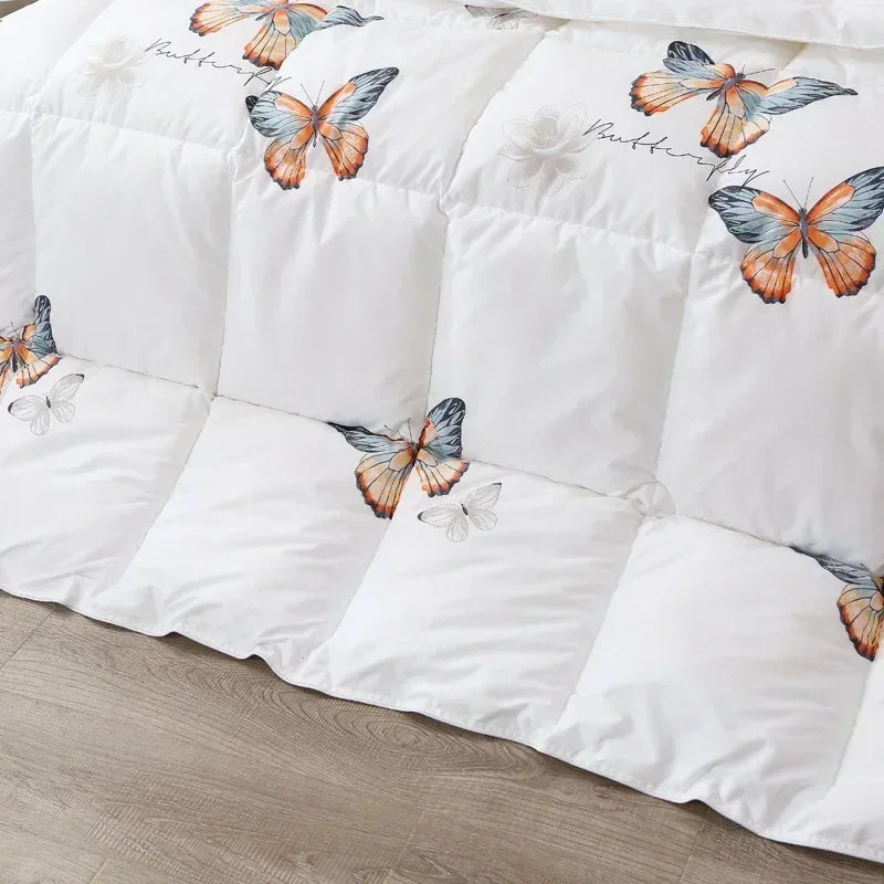 White goose down quilt with vibrant orange and blue butterfly print on white quilted comforter for winter bedding
