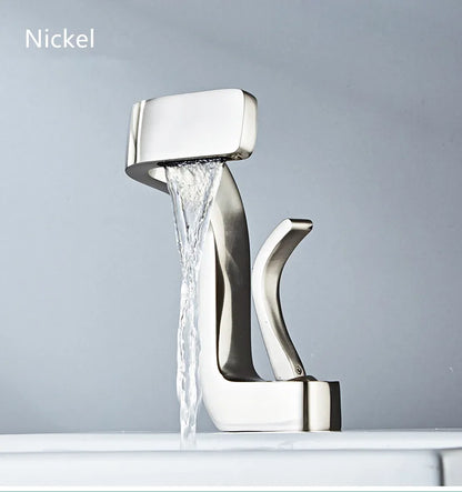 Modern single hole nickel-finished brass bathroom faucet with sleek angular design and flowing waterfall water stream
