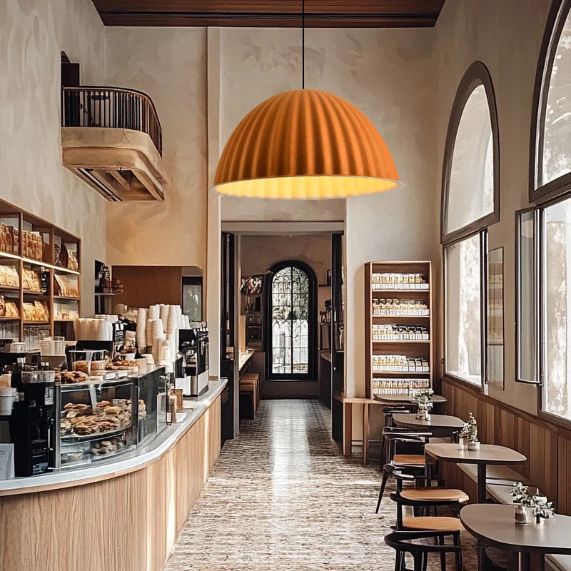 A warm orange-toned felt pendant light with ribbed design hanging from ceiling for acoustic office use