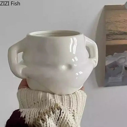 Cream-colored ceramic planter with two sculpted handles and glossy finish from festive white santa claus ceramic mug set