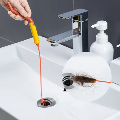Flexible orange and yellow drain cleaner brush with a long thin cord for kitchen clog removal