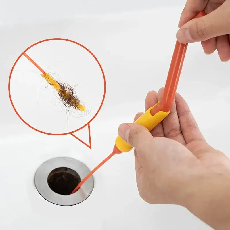 Flexible orange and yellow plastic drain cleaner brush with tapered tip for removing hair and debris from kitchen sinks