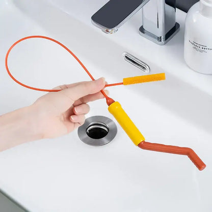 Flexible orange and yellow decorbites drain cleaner brush with textured head for kitchen hair removal and clog clearing