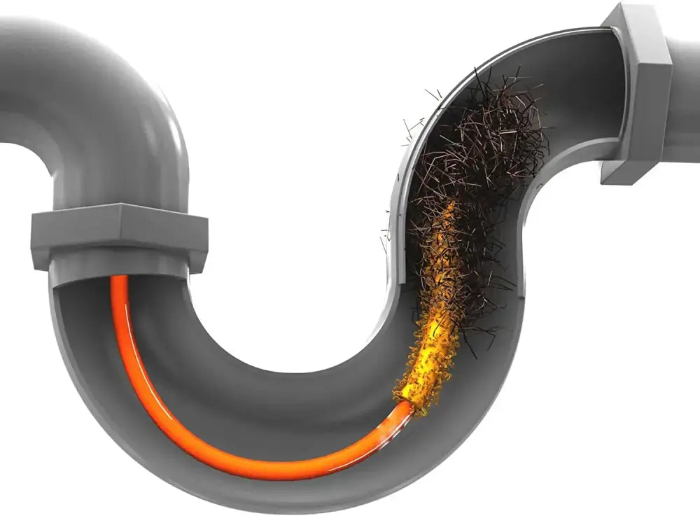 Flexible orange and yellow decorbites drain cleaner brush removing dark hair and debris from a gray plastic sink drain