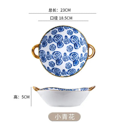 A white ceramic double ear ramen soup bowl with blue floral patterns and gold handles labeled xiao qinghua decorbites ceramic double