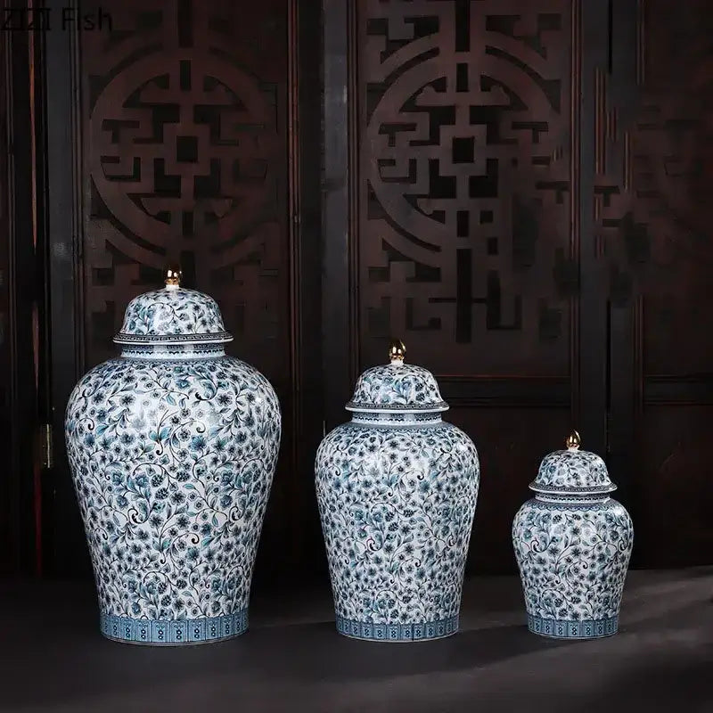 Three blue and white ceramic ginger jars with intricate floral patterns and golden finials for living room decorbites decor