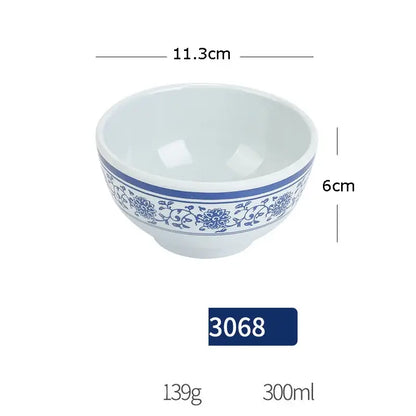 White imitation porcelain dinner set bowl with blue floral and vine pattern and solid blue band around rim