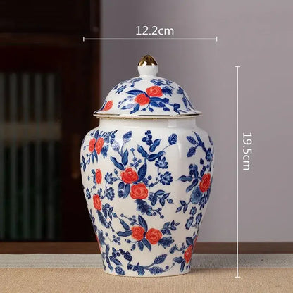 White porcelain tea pot storage container with vibrant red roses and blue foliage floral pattern for kitchen use