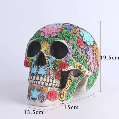 A vibrantly decorated floral colorful skull ornament with intricate patterns in pink blue red green and yellow on gray base