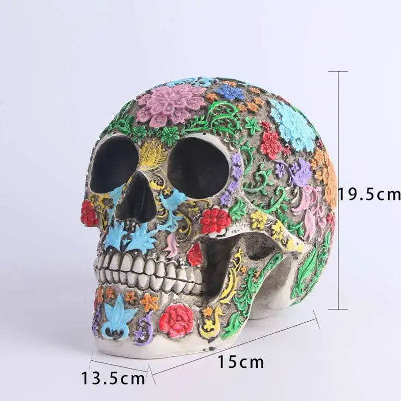 A vibrantly decorated floral colorful skull ornament with intricate patterns in pink blue red green and yellow on gray base