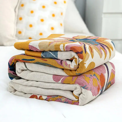 Stack of decorbites cotton summer cotton summer blankets with vibrant floral patterns on soft beige fabric for bedroom decor