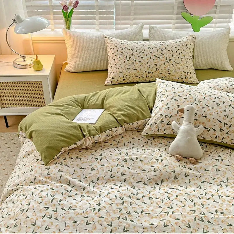 Floral cream and peach double layer cotton quilt cover set with olive green and cream floral pattern and plush white duck toy