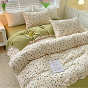 Cream-colored cotton quilt cover set with delicate floral peach and green pattern with matching pillowcases
