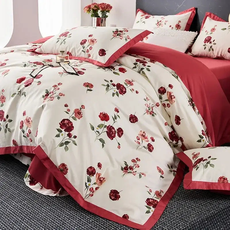 Cream-colored egyptian cotton bedding set with vibrant red rose floral pattern and matching red satin trim
