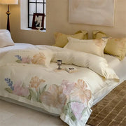 Cream-colored satin bed linens with delicate watercolor florals in soft pinks and greens made from decorbites 100s egyptian cotton