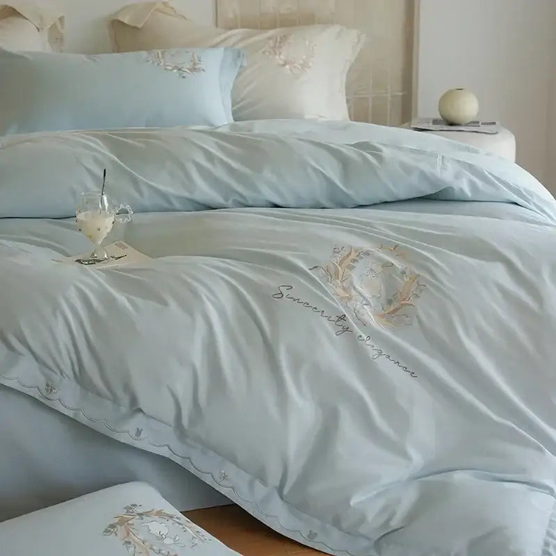 Light blue satin duvet cover set with delicate floral embroidery and sincerity stitched in gold thread for bedroom decor