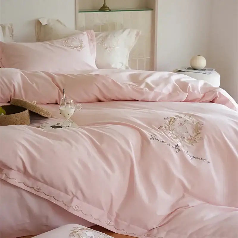 Pink satin duvet cover set with delicate gold embroidery and scalloped edge for elegant bedroom decor