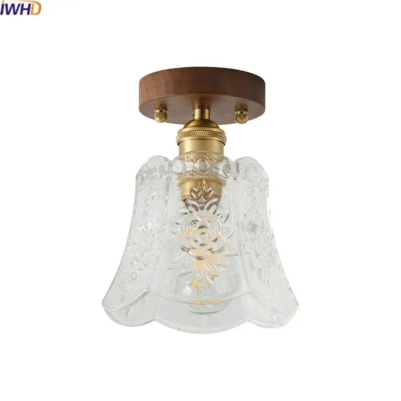 Clear glass led ceiling lamp with floral etching mounted on brass fixture and walnut ceiling plate for living room